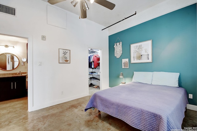 831 S Flores Unit 2212, San Antonio, TX 78204 - bedroom with a spacious closet, a closet, ensuite bathroom, a sink, and baseboards