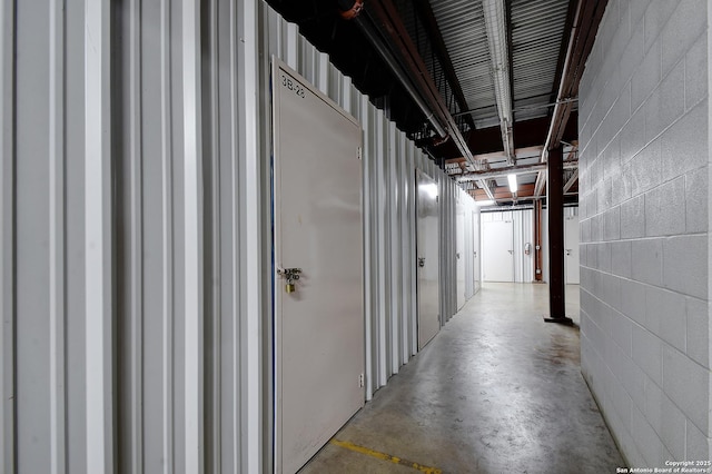831 S Flores Unit 2212, San Antonio, TX 78204 - corridor featuring concrete block wall and concrete flooring
