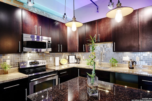 831 S Flores Unit 2212, San Antonio, TX 78204 - kitchen with appliances with stainless steel finishes, a sink, stone counters, backsplash, and decorative light fixtures