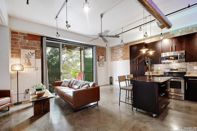 831 S Flores Unit 2212, San Antonio, TX 78204 - kitchen featuring stainless steel appliances, concrete flooring, a kitchen breakfast bar, and open floor plan