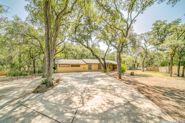 6514 W Ave, Castle Hills, TX 78213 - ranch-style home featuring driveway and view of scattered trees