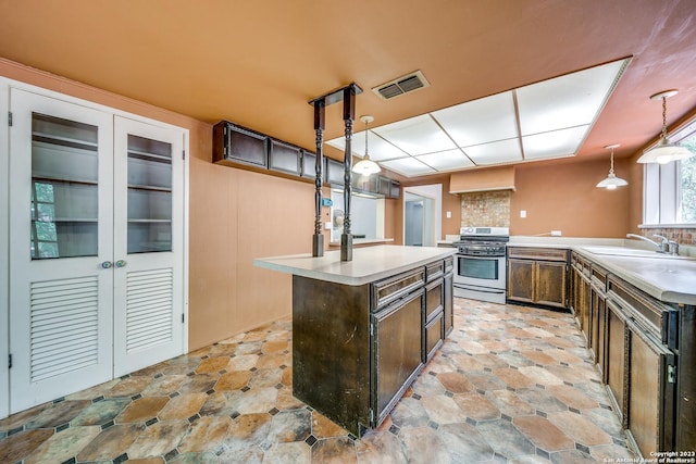 6514 W Ave, Castle Hills, TX 78213 - kitchen with gas stove, a center island, pendant lighting, light countertops, and a sink
