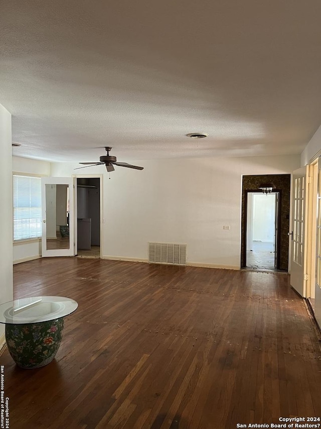 6514 W Ave, Castle Hills, TX 78213 - unfurnished living room with wood-type flooring, baseboards, and a ceiling fan