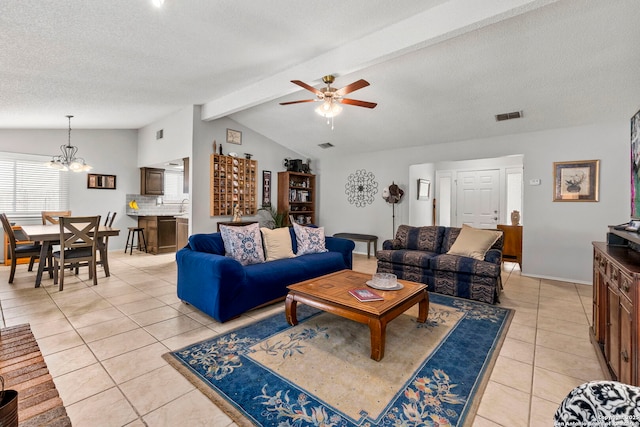 2866 Burning Rock, San Antonio, TX 78247 - living area with light tile patterned floors, ceiling fan, a chandelier, a textured ceiling, and baseboards