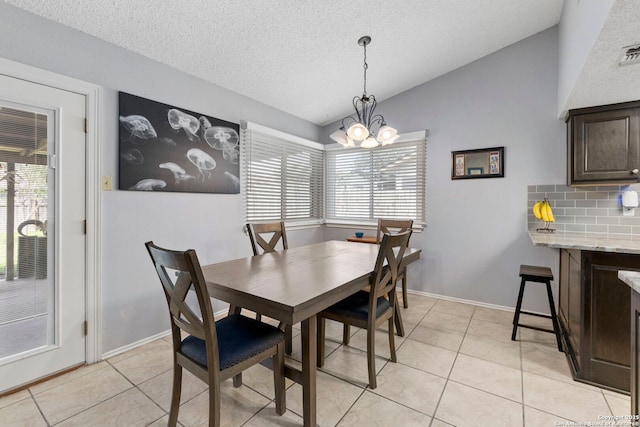 2866 Burning Rock, San Antonio, TX 78247 - dining room featuring lofted ceiling, a chandelier, light tile patterned floors, a textured ceiling, and baseboards