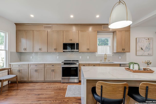 264 E Lullwood, San Antonio, TX 78212 - kitchen with appliances with stainless steel finishes, a sink, light brown cabinetry, plenty of natural light, and recessed lighting