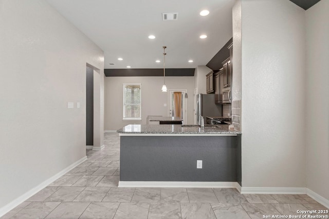 8339 Percheron Pass, San Antonio, TX 78254 - kitchen with light marble finish flooring, light stone counters, baseboards, hanging light fixtures, and recessed lighting