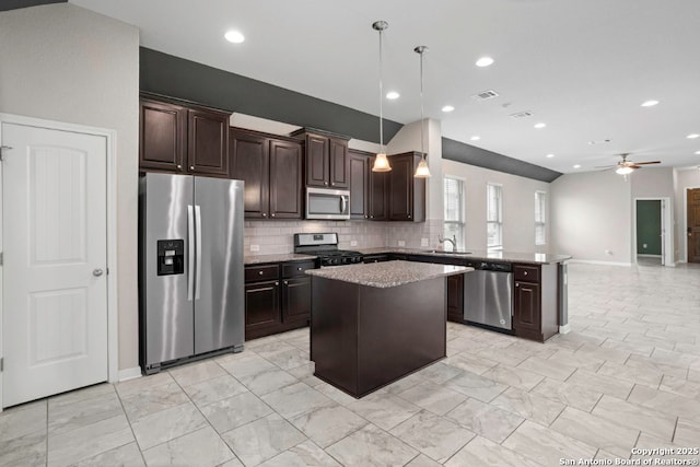 8339 Percheron Pass, San Antonio, TX 78254 - kitchen with appliances with stainless steel finishes, dark brown cabinets, a peninsula, a kitchen island, and baseboards