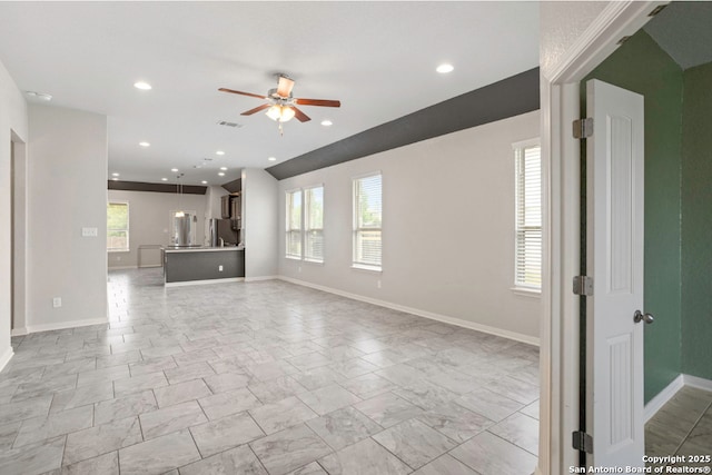 8339 Percheron Pass, San Antonio, TX 78254 - unfurnished living room with a ceiling fan, healthy amount of natural light, marble look tile flooring, and recessed lighting