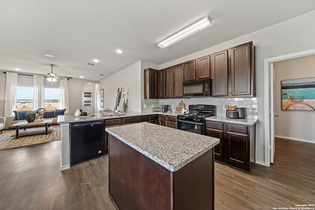 9302 Graze Land Dr, San Antonio, TX 78211 - kitchen featuring black appliances, dark brown cabinetry, dark wood-type flooring, a peninsula, and a center island