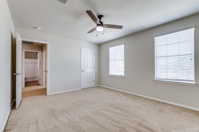 10907 Shoo Fly, San Antonio, TX 78245 - unfurnished bedroom featuring light colored carpet, a textured ceiling, a ceiling fan, and a closet