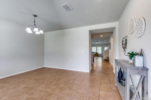 10907 Shoo Fly, San Antonio, TX 78245 - unfurnished room with a chandelier, stairway, a textured ceiling, light tile patterned floors, and a ceiling fan