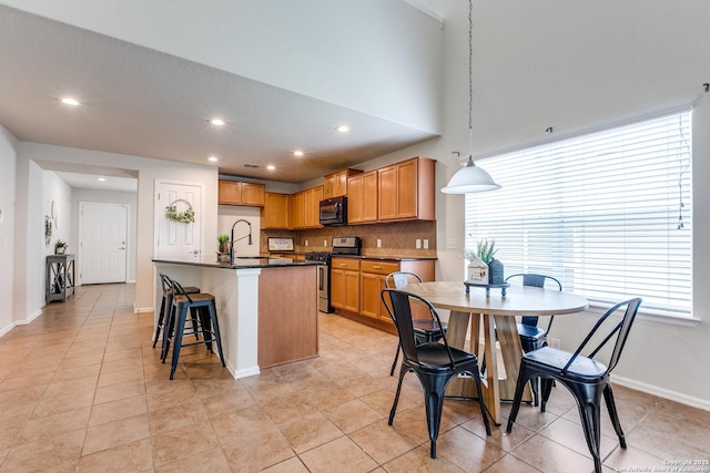 10907 Shoo Fly, San Antonio, TX 78245 - kitchen featuring stainless steel gas stove, black microwave, dark countertops, recessed lighting, and light tile patterned floors