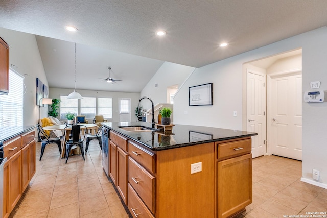 10907 Shoo Fly, San Antonio, TX 78245 - kitchen featuring vaulted ceiling, light tile patterned flooring, dark stone countertops, an island with sink, and ceiling fan