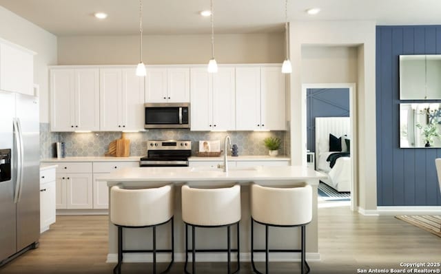 6515 Morgan Gln, San Antonio, TX 78253 - kitchen featuring stainless steel appliances, a sink, light wood-style floors, tasteful backsplash, and recessed lighting
