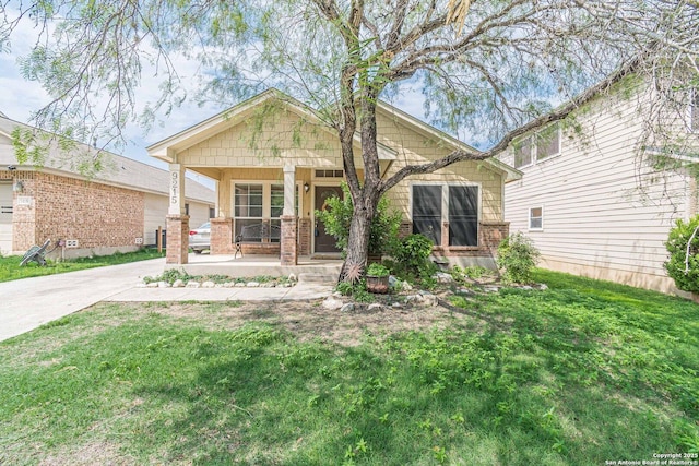9215 Hilltop Xing, San Antonio, TX 78251 - view of front of property featuring covered porch, a front lawn, and brick siding