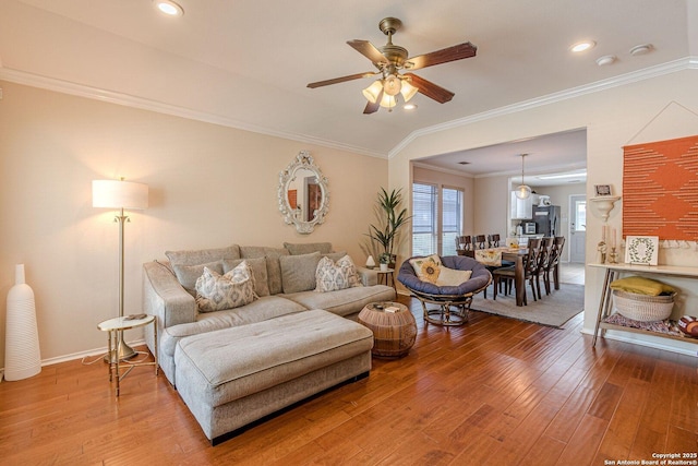 9215 Hilltop Xing, San Antonio, TX 78251 - living room featuring ceiling fan, hardwood / wood-style flooring, ornamental molding, recessed lighting, and baseboards