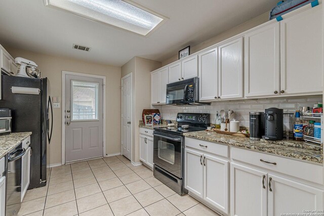 9215 Hilltop Xing, San Antonio, TX 78251 - kitchen featuring black appliances, white cabinetry, light tile patterned flooring, decorative backsplash, and light stone countertops