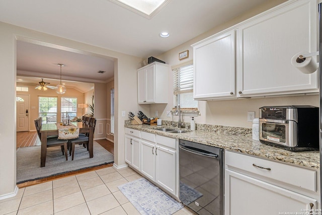 9215 Hilltop Xing, San Antonio, TX 78251 - kitchen with black dishwasher, a sink, white cabinets, a ceiling fan, and ornamental molding