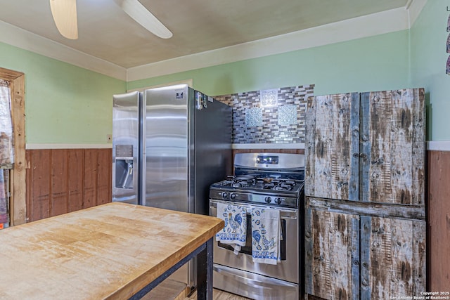935 Gembler, San Antonio, TX 78219 - kitchen with stainless steel appliances, a wainscoted wall, wood walls, backsplash, and ceiling fan