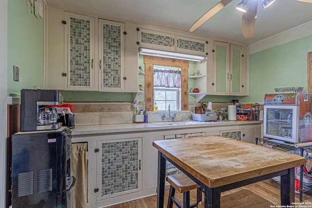 935 Gembler, San Antonio, TX 78219 - kitchen featuring a sink, light countertops, a ceiling fan, and wood finished floors