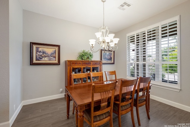 28515 Vogelsdorf, Boerne, TX 78006 - dining area featuring dark wood-style floors, a chandelier, and baseboards