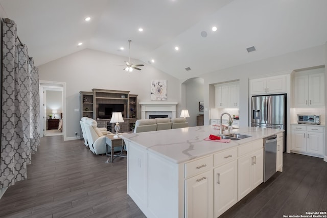 28515 Vogelsdorf, Boerne, TX 78006 - kitchen featuring stainless steel appliances, a ceiling fan, a sink, a fireplace, and dark wood-type flooring