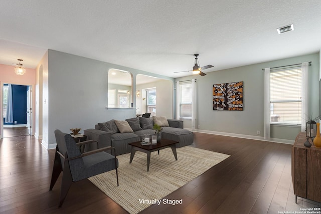 15122 Cinnamon Teal, San Antonio, TX 78253 - living room with hardwood / wood-style floors, baseboards, ceiling fan, a textured ceiling, and arched walkways