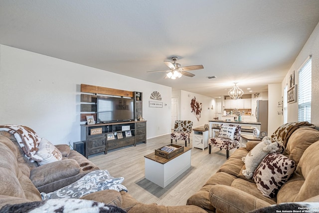 14616 Stable Spgs, Elmendorf, TX 78112 - living area with light wood finished floors, a chandelier, and ceiling fan