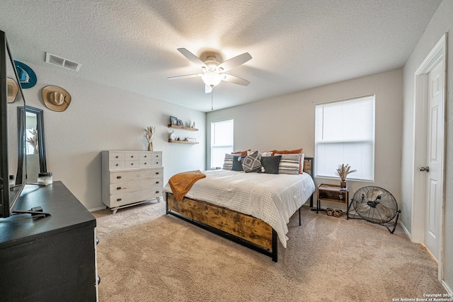 14616 Stable Spgs, Elmendorf, TX 78112 - bedroom with light colored carpet, a ceiling fan, and a textured ceiling