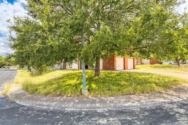 7026 Elmbank, San Antonio, TX 78244 - obstructed view of property featuring concrete driveway and brick siding