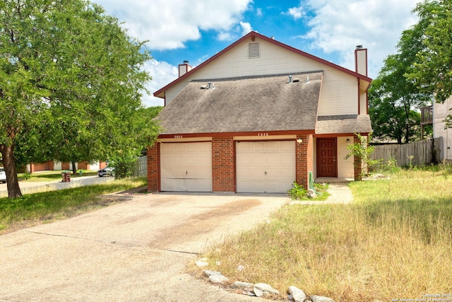 7026 Elmbank, San Antonio, TX 78244 - view of front of home with a chimney, a shingled roof, concrete driveway, and brick siding