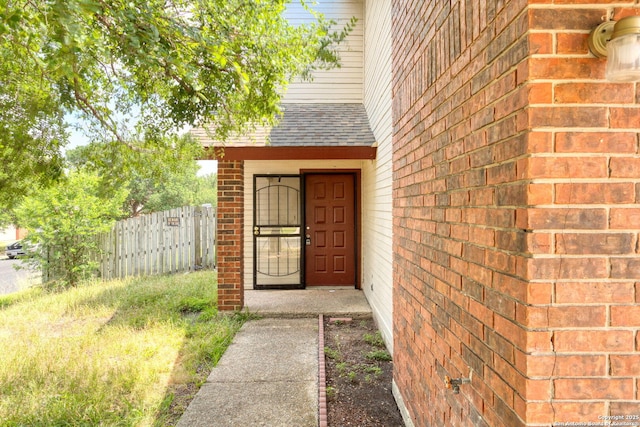 7026 Elmbank, San Antonio, TX 78244 - view of exterior entry featuring brick siding and a shingled roof