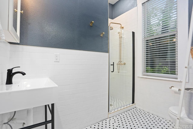 1106 W Summit Ave, San Antonio, TX 78201 - bathroom with tile walls, a shower stall, toilet, wainscoting, and a textured wall