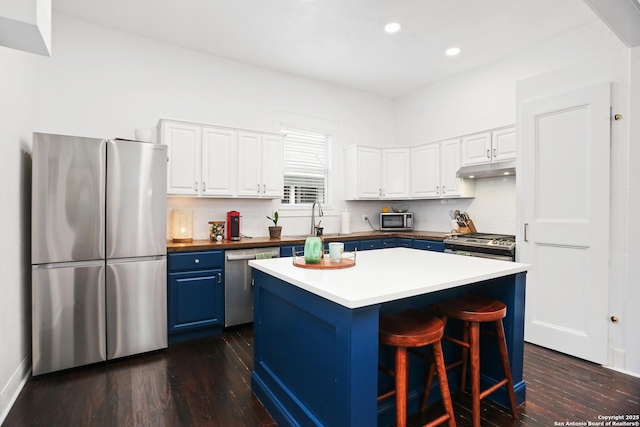 1106 W Summit Ave, San Antonio, TX 78201 - kitchen with stainless steel appliances, blue cabinetry, dark wood finished floors, white cabinets, and recessed lighting