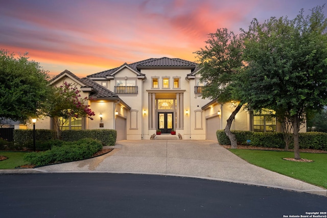 21302 Ronda De Cadiz, San Antonio, TX 78257 - mediterranean / spanish-style home with a balcony, french doors, driveway, a garage, and stucco siding