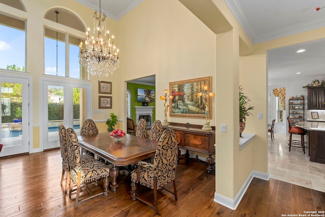 21302 Ronda De Cadiz, San Antonio, TX 78257 - dining area featuring hardwood / wood-style floors, baseboards, ornamental molding, french doors, and a towering ceiling