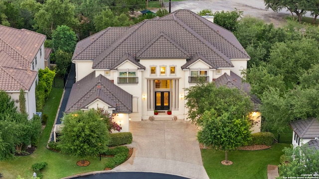 21302 Ronda De Cadiz, San Antonio, TX 78257 - view of front of house with a balcony, stucco siding, a tiled roof, and french doors
