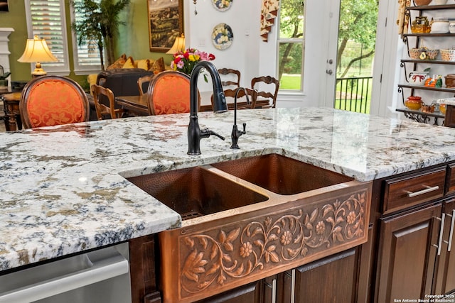 21302 Ronda De Cadiz, San Antonio, TX 78257 - kitchen featuring a sink, light stone countertops, dark brown cabinetry, and stainless steel dishwasher