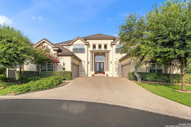 21302 Ronda De Cadiz, San Antonio, TX 78257 - mediterranean / spanish home featuring french doors, concrete driveway, stucco siding, a tiled roof, and a garage