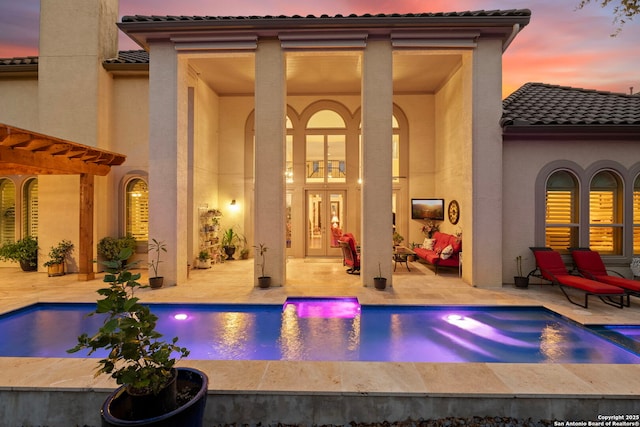 21302 Ronda De Cadiz, San Antonio, TX 78257 - back of house featuring a tile roof, a patio area, stucco siding, french doors, and a pool with connected hot tub