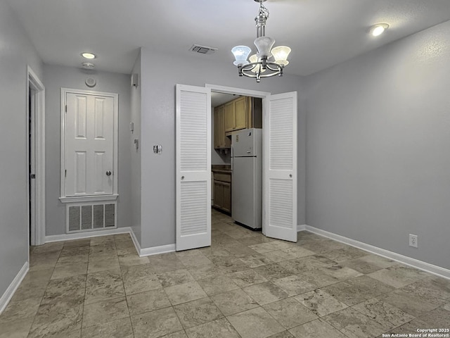 201 Craig Pl Apt B, San Antonio, TX 78212 - unfurnished dining area featuring a chandelier, baseboards, and light stone finish flooring
