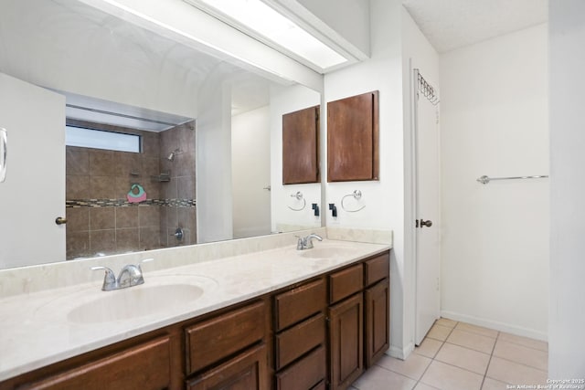 7738 Chambers Rd Unit 1203, San Antonio, TX 78229 - bathroom featuring double vanity, tile patterned flooring, and tiled shower