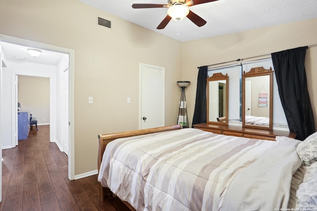 7738 Chambers Rd Unit 1203, San Antonio, TX 78229 - bedroom featuring dark wood-type flooring, baseboards, and ceiling fan
