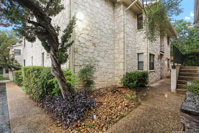 7738 Chambers Rd Unit 1203, San Antonio, TX 78229 - view of side of home featuring stone siding