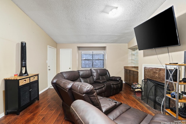 7738 Chambers Rd Unit 1203, San Antonio, TX 78229 - living room with a textured ceiling, dark wood finished floors, baseboards, lofted ceiling, and a premium fireplace