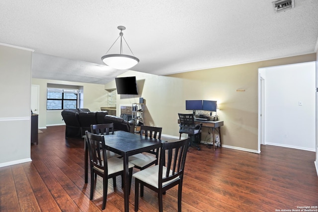 7738 Chambers Rd Unit 1203, San Antonio, TX 78229 - dining space with hardwood / wood-style flooring, a textured ceiling, and baseboards