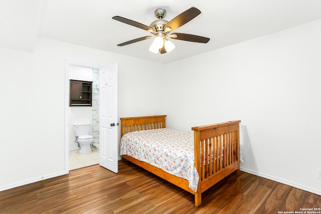 8633 Datapoint Unit 236, San Antonio, TX 78229 - bedroom featuring wood finished floors, connected bathroom, ceiling fan, and baseboards