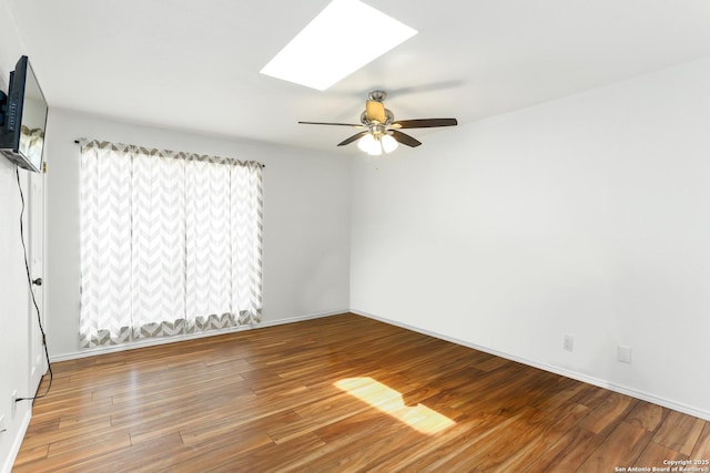 8633 Datapoint Unit 236, San Antonio, TX 78229 - spare room with a skylight, wood finished floors, a ceiling fan, and baseboards