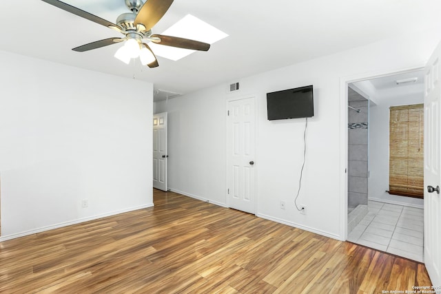 8633 Datapoint Unit 236, San Antonio, TX 78229 - unfurnished bedroom with wood finished floors, baseboards, ensuite bath, ceiling fan, and a closet